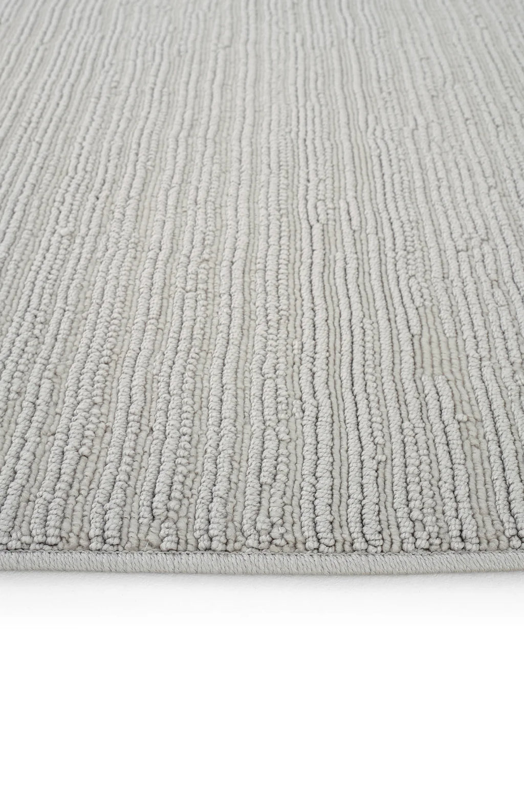 Açık gri renkli, dokulu, çizgili yumuşak örgü halı köşe detayı