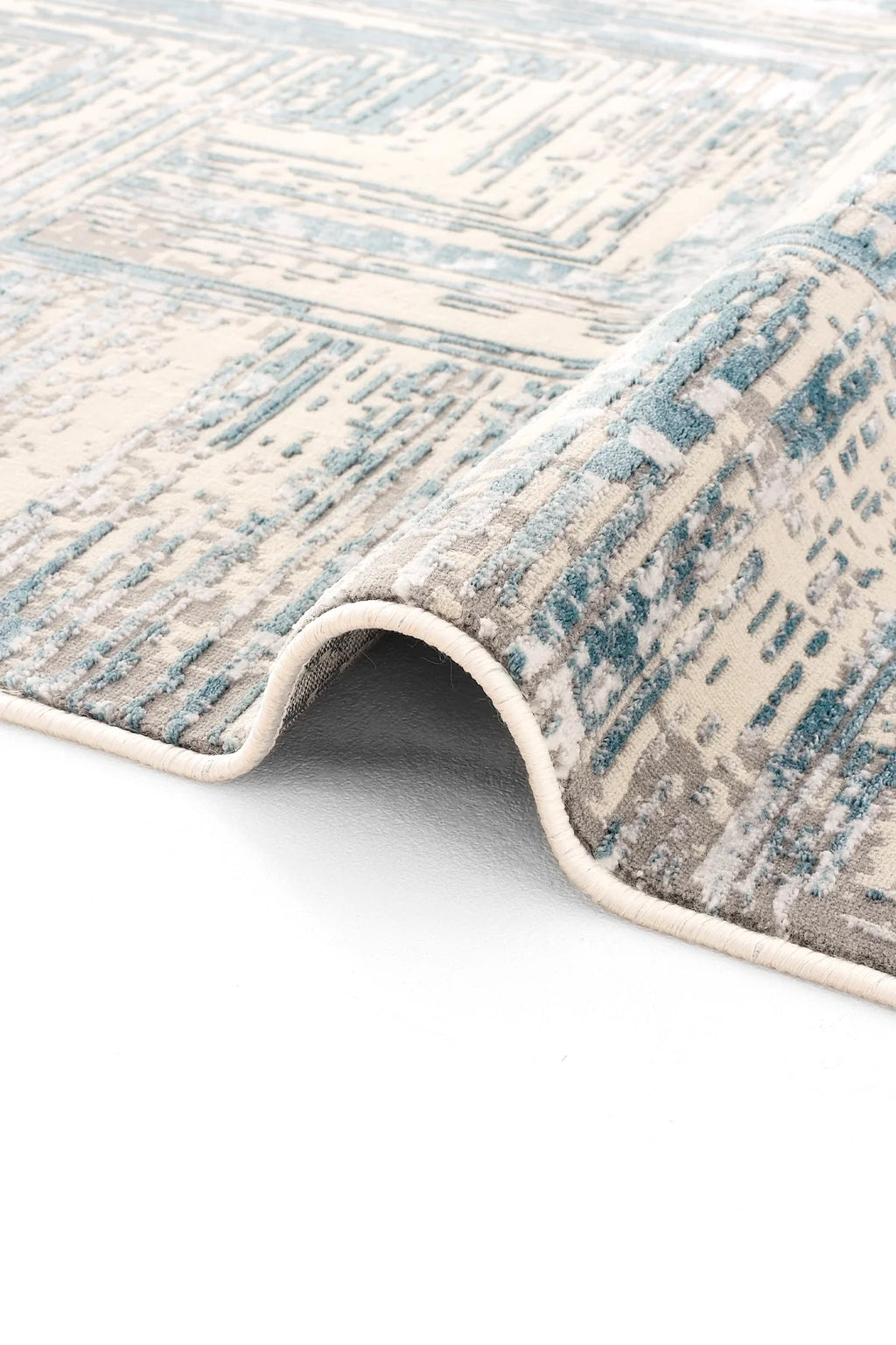 Mavi, gri ve krem renklerde modern desenli Luxess Hermes halı detayı