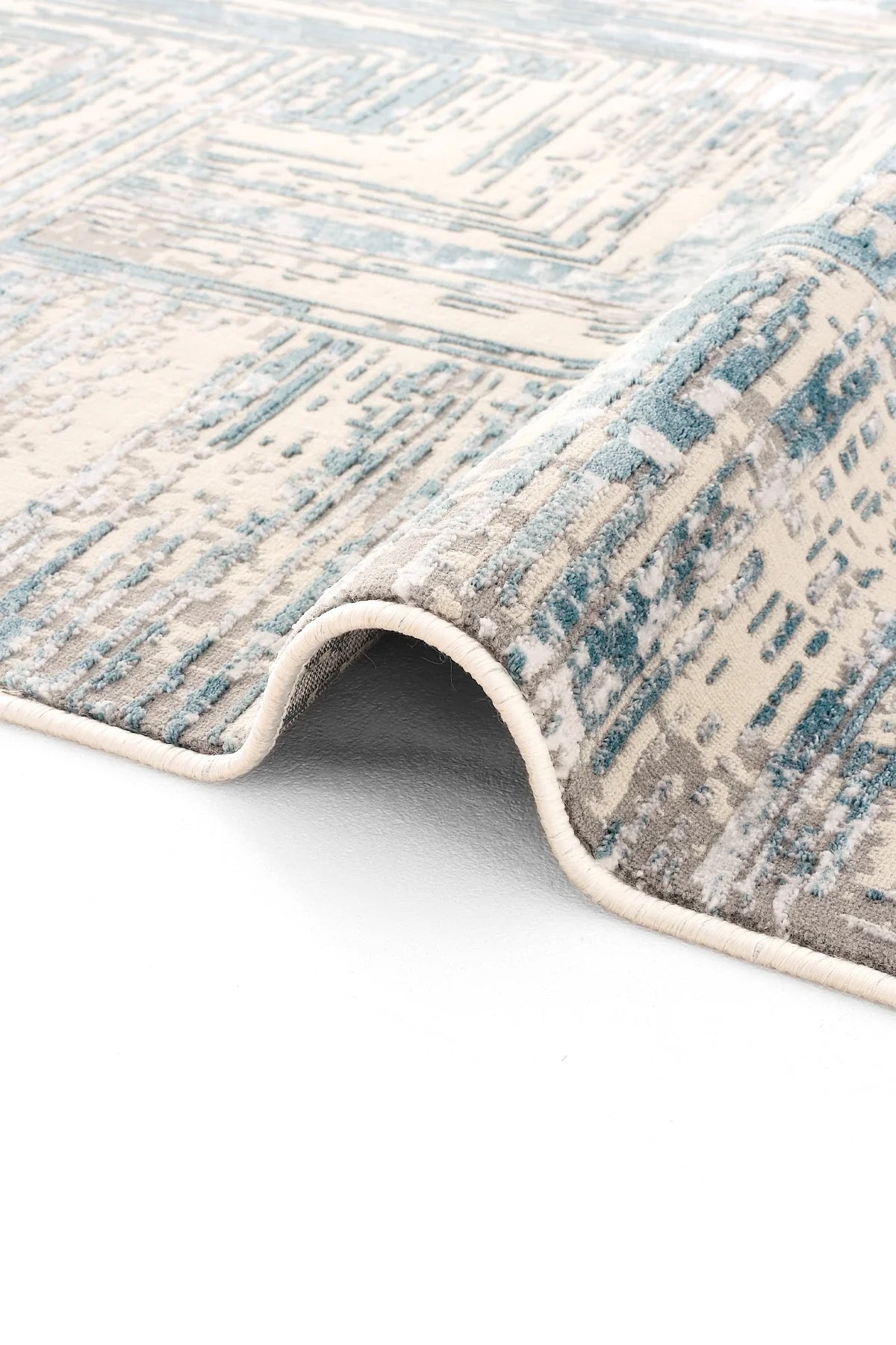 Mavi, gri ve krem renklerde modern desenli Luxess Hermes halı detayı