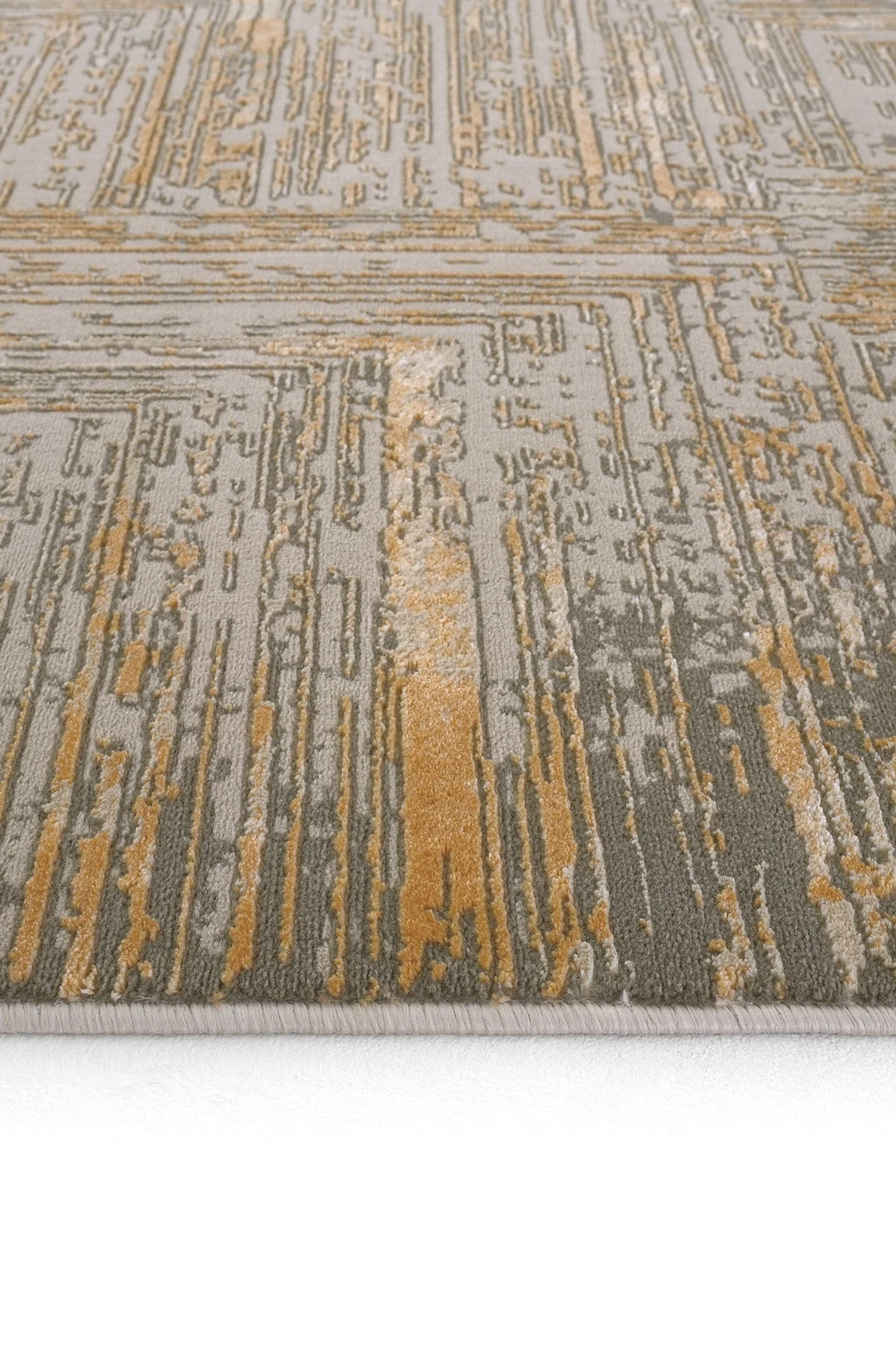 Gri ve altın renklerin karışımıyla soyut geometrik desenli modern halı detayı